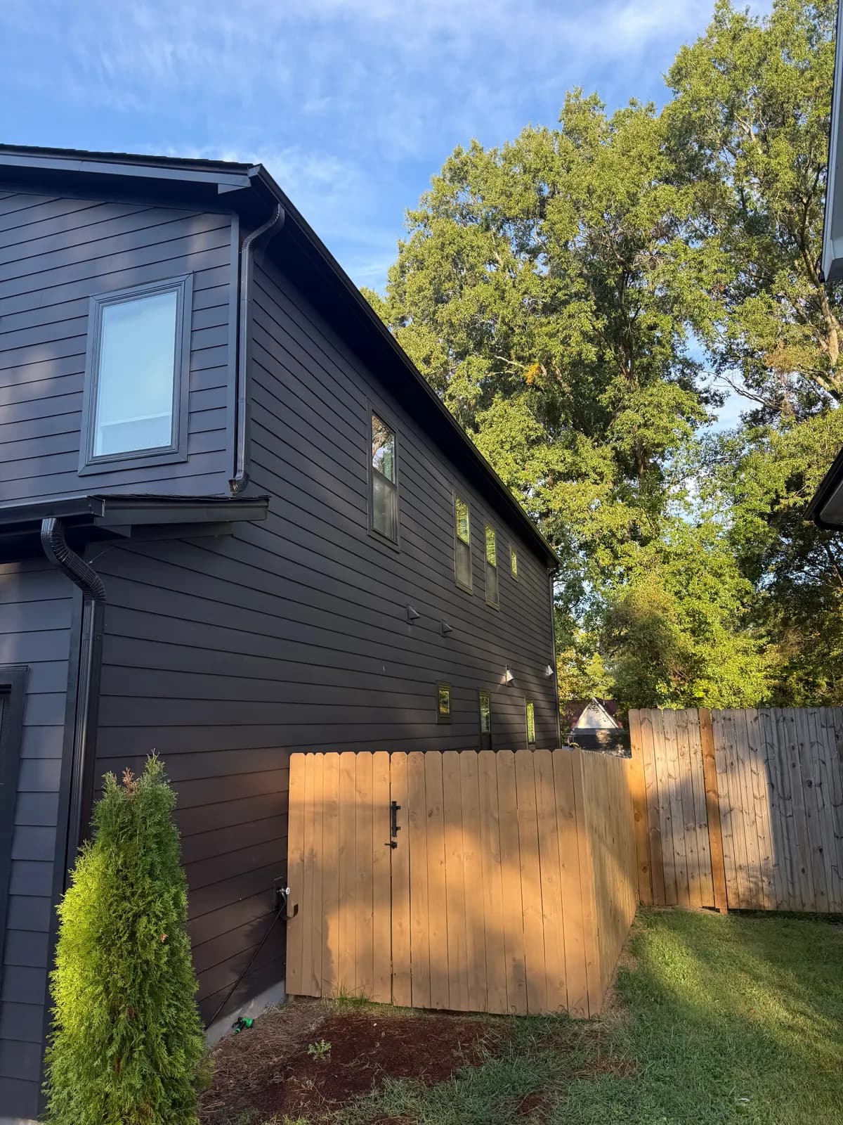 Modern two-story with charcoal lap siding and black gutters and downspouts in the Charlotte, NC area