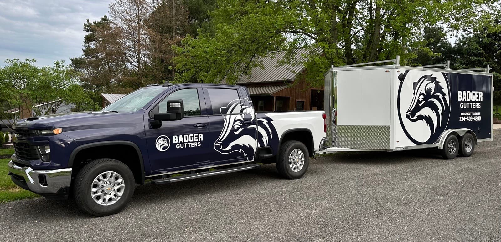 The Badger Gutters truck and enclosed trailer, loaded for a gutter install