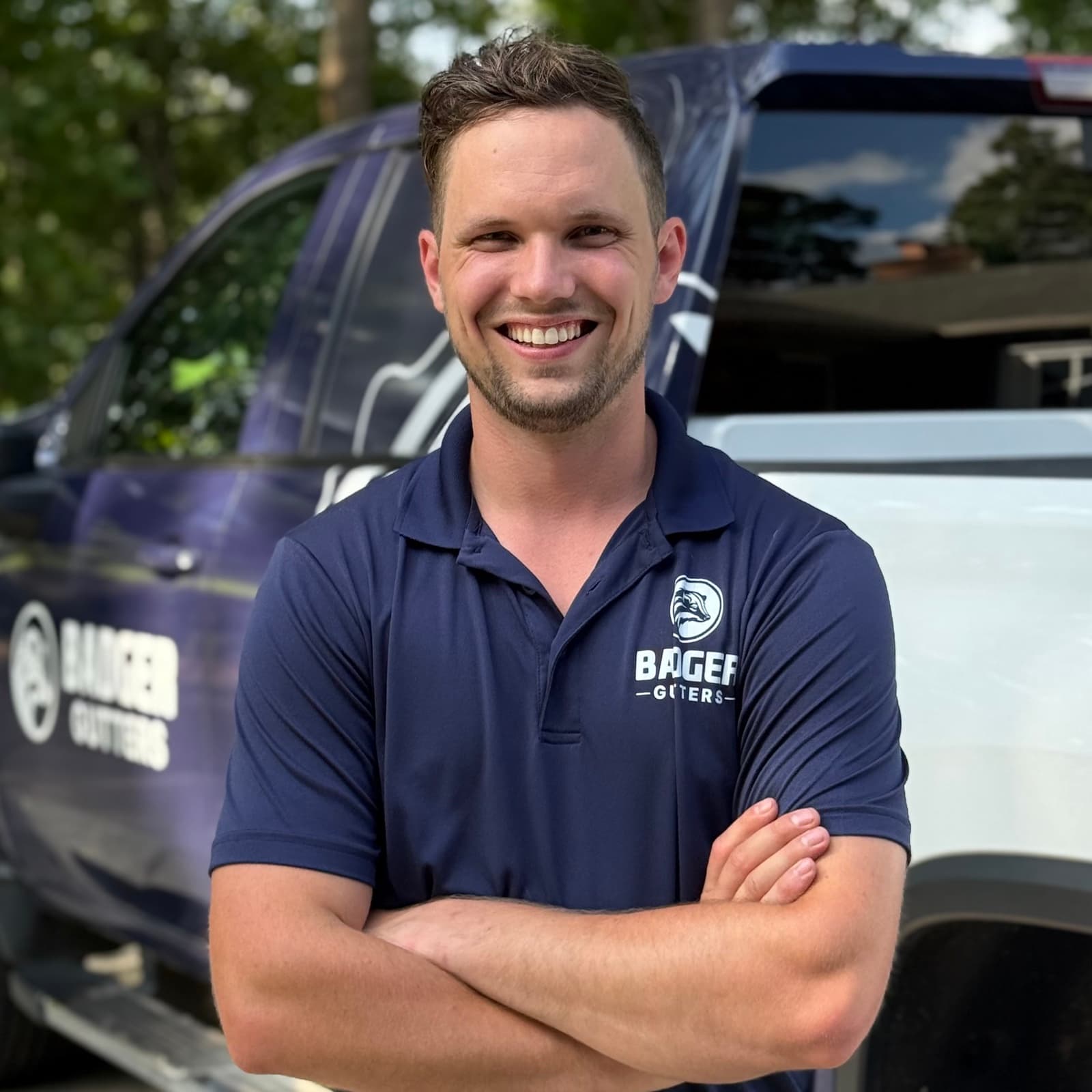 Ben Krupp, owner of Badger Gutters, in front of a Badger Gutters truck in Charlotte, NC