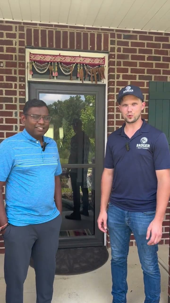 Ben Krupp with Harikrishna N., a Badger Gutters customer, outside his home in Harrisburg, NC